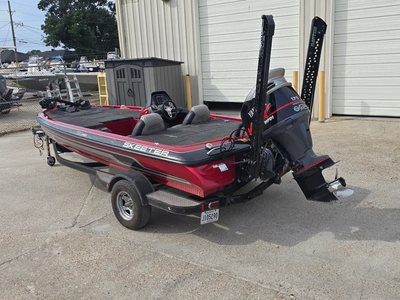 Slide: The Image of 2014 Skeeter ZX 190 boat with Yamaha engine on trailer, parked outside a building. - 6