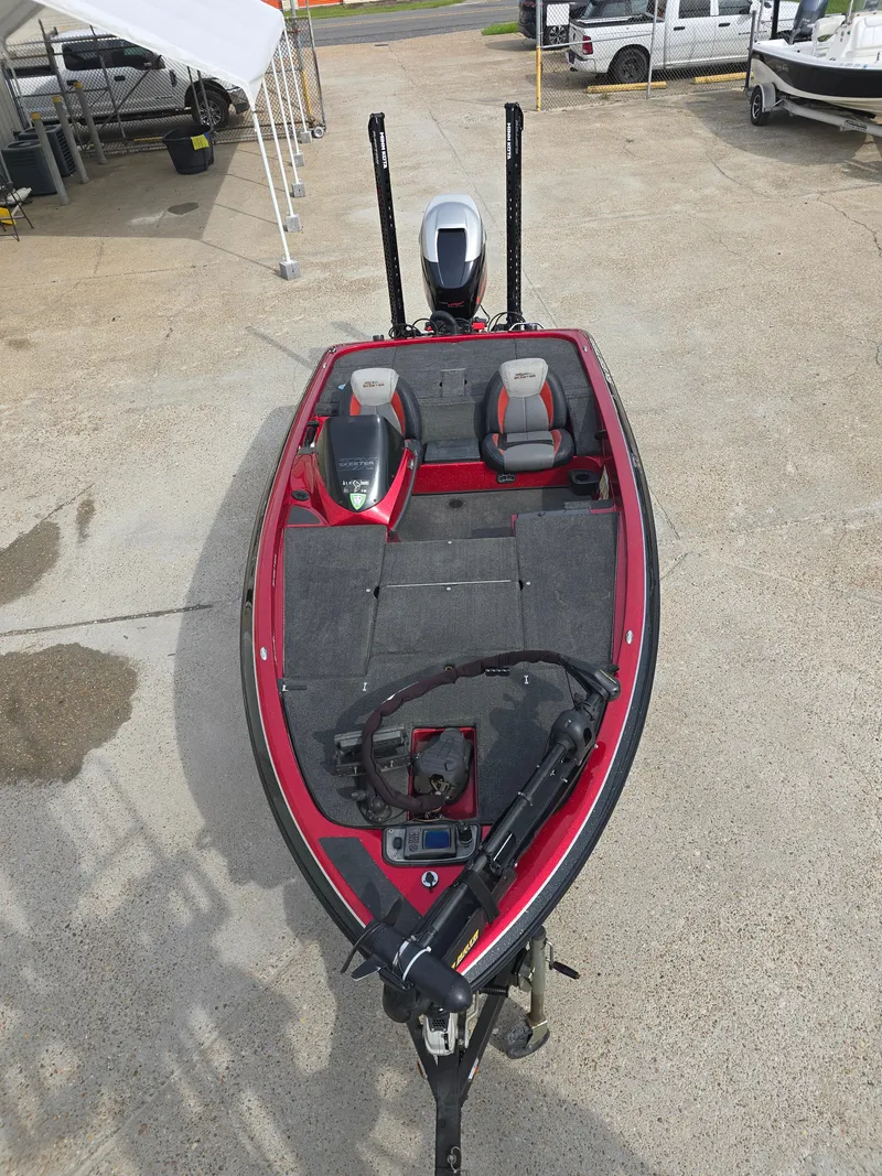Slide: The Image of 2014 Skeeter ZX 190 boat with red and gray seating, parked on concrete. - 9