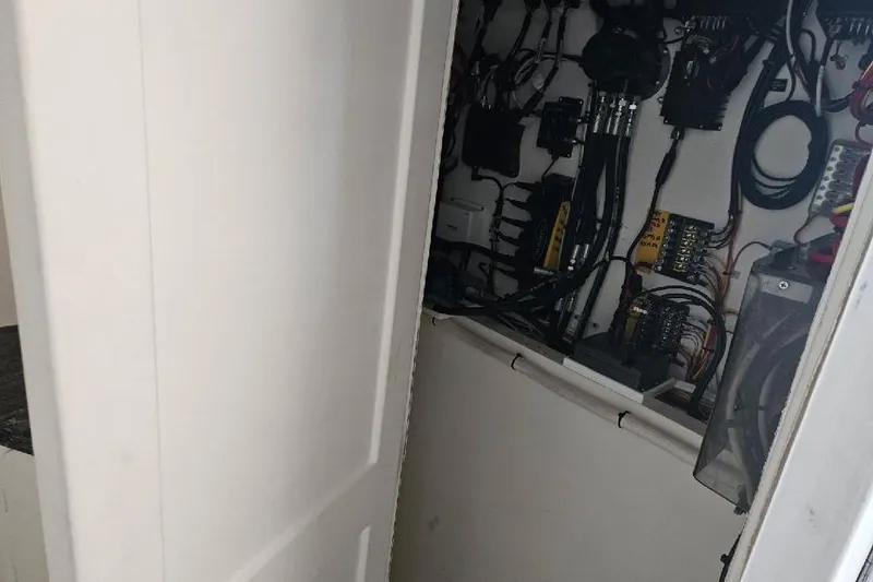 Slide: The Image of Electrical panel with wiring inside a partially open white door, Flowers Down East 2022 model. - 10