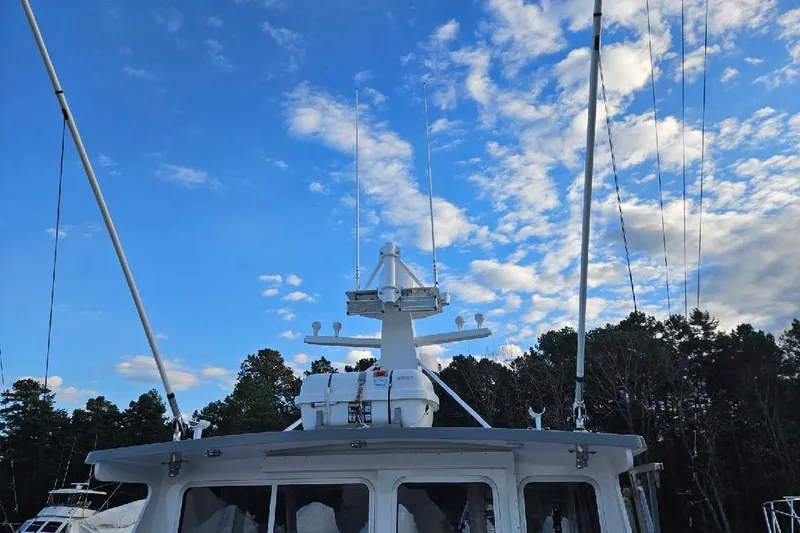 Slide: The Image of 2022 Flowers Down East boat under a vibrant blue sky with scattered clouds. - 11