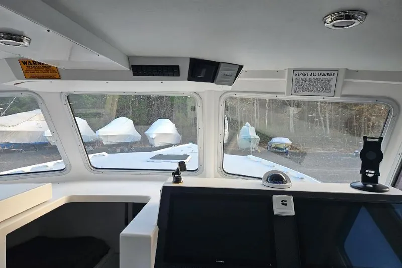 Slide: The Image of Interior view of a 2022 Flowers Down East boat with covered boats outside. - 13