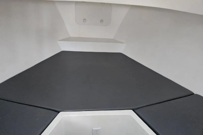 Slide: The Image of Interior of 2022 Flowers Down East boat with cushioned seating and storage. - 14