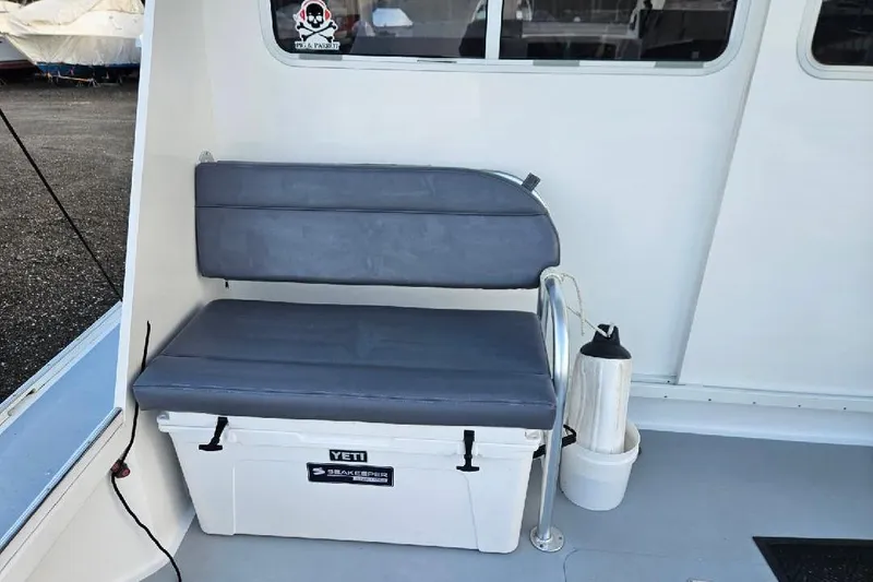 Slide: The Image of Boat interior with cushioned seat on a Yeti cooler, Flowers Down East model, 2022. - 23