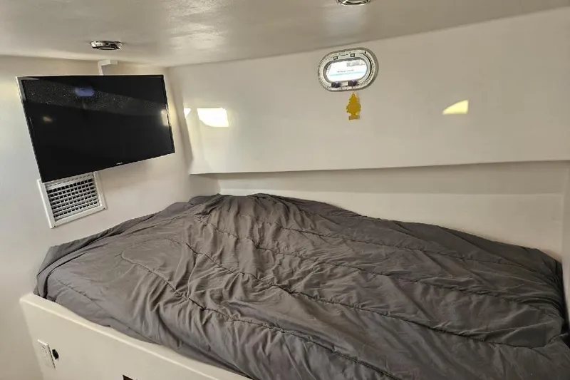 Slide: The Image of Cozy boat cabin interior with bed, TV, and porthole, Flowers Down East 2022 model. - 28