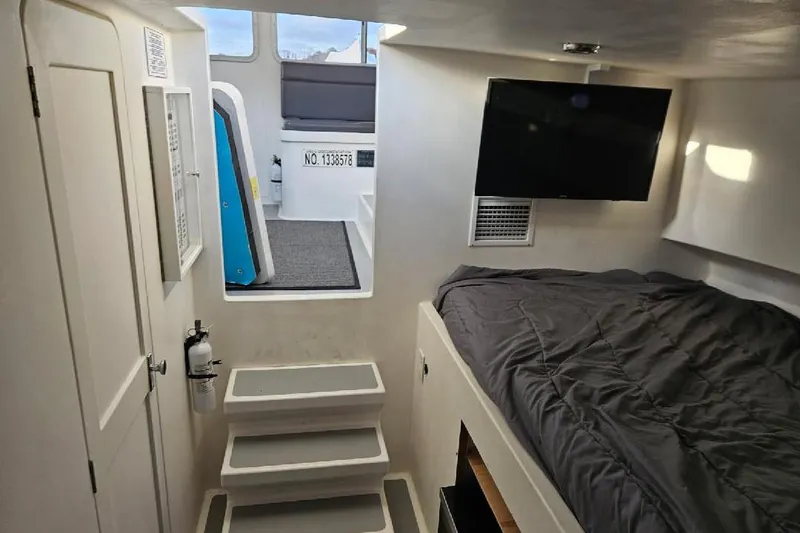 Slide: The Image of Cozy boat cabin interior with bed, TV, and stairs, Flowers Down East 2022 model. - 29