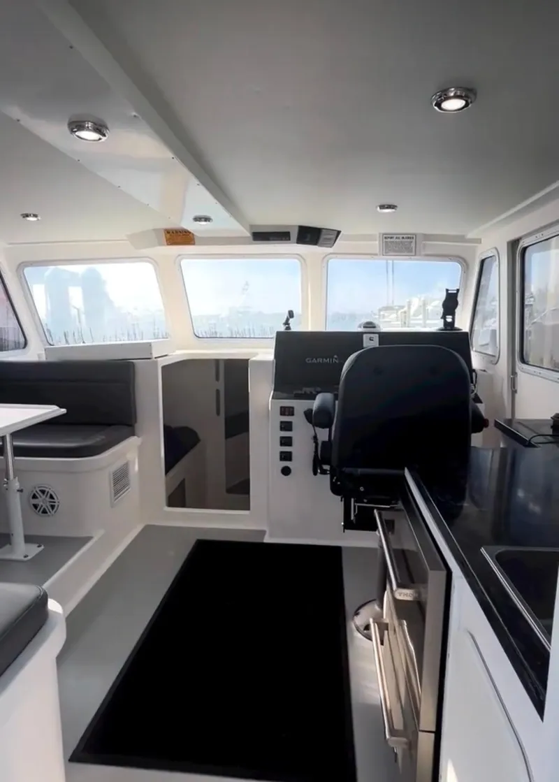 Slide: The Image of Interior of a 2022 Flowers Down East boat with seating and table. - 4