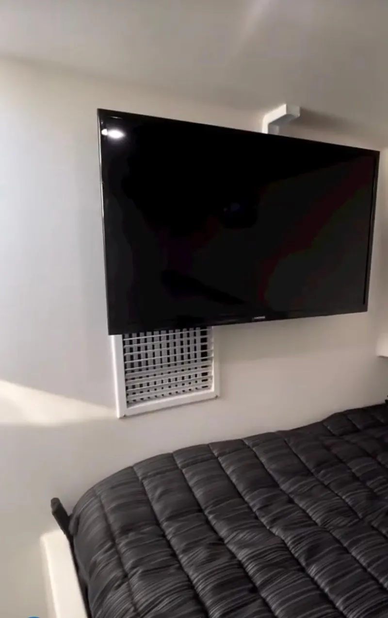 Slide: The Image of Interior of a 2022 Flowers Down East boat with a TV and control panel. - 6