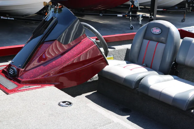 Slide: The Image of 2016 Ranger RT 188 boat interior with gray and red seating, steering console, and carpeted floor. - 14