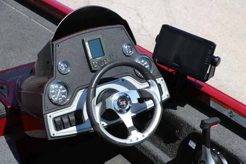 Slide: The Image of 2016 Ranger RT 188 boat dashboard with steering wheel, gauges, and navigation screens. - 16