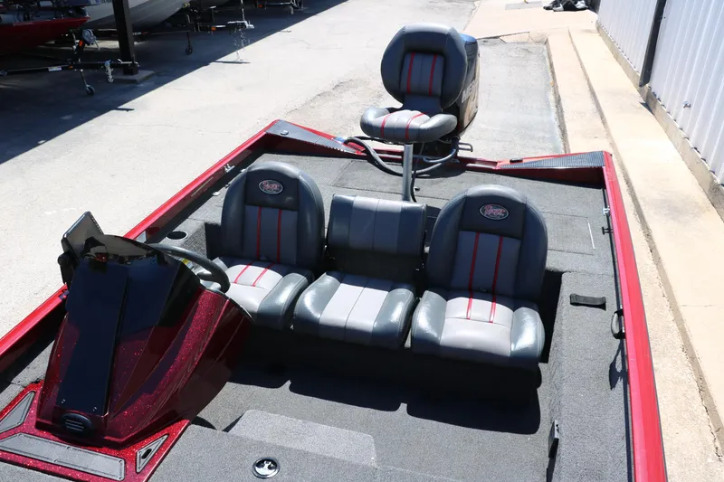 Slide: The Image of 2016 Ranger RT 188 boat interior with gray and red seating, parked outdoors. - 23