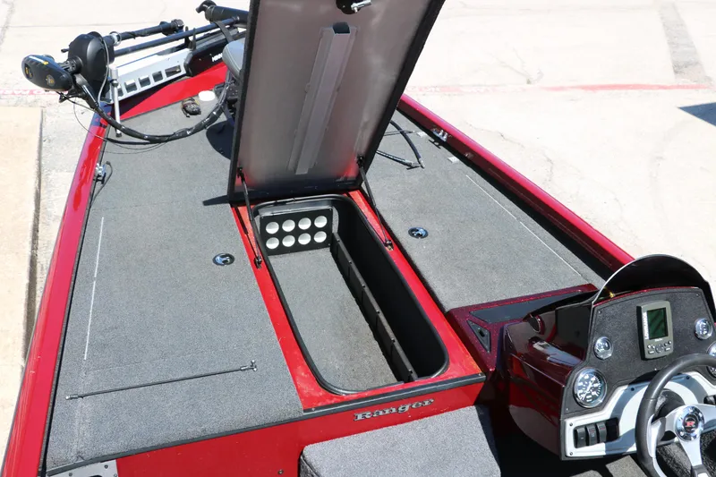Slide: The Image of 2016 Ranger RT 188 boat interior with open storage compartment and control panel. - 27