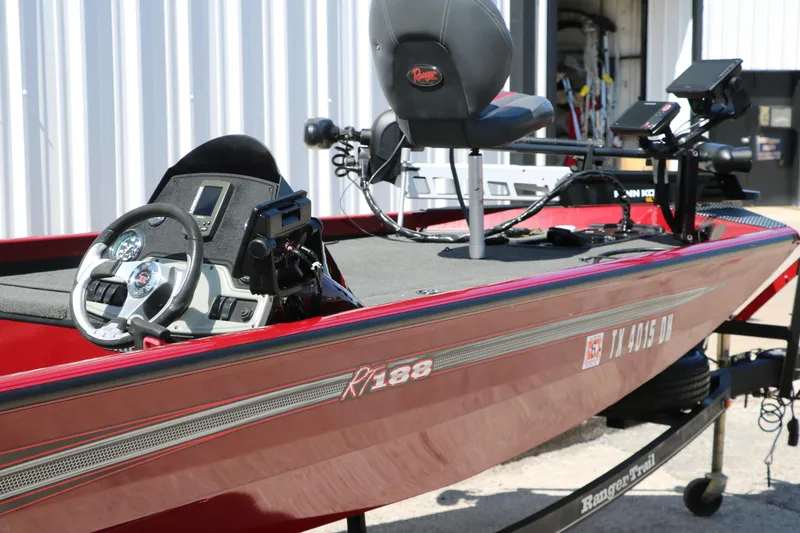 Slide: The Image of 2016 Ranger RT 188 boat with steering wheel and electronics, parked outdoors. - 30