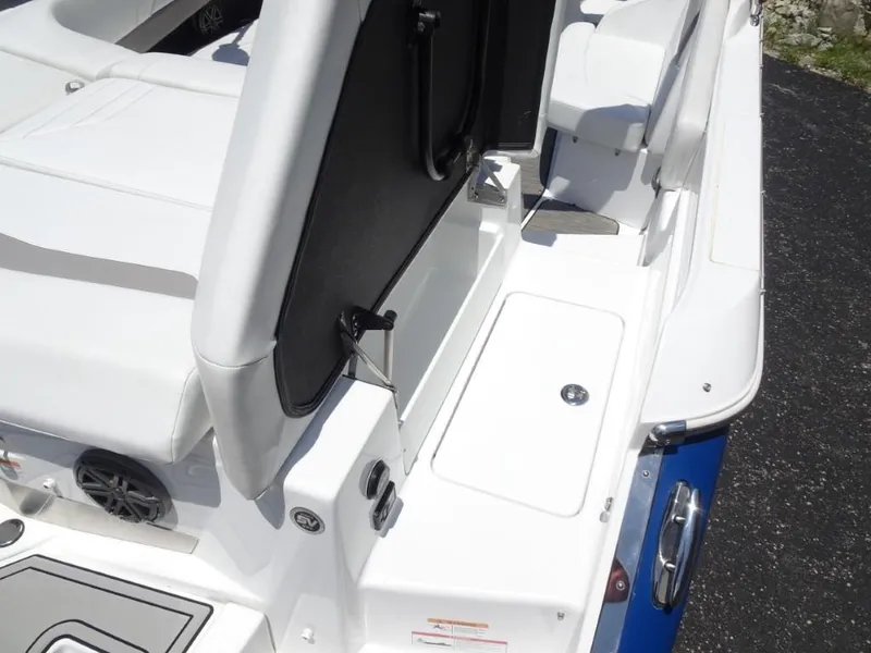 Slide: The Image of 2023 Four Winns H260 boat interior with white seating and storage compartment. - 10