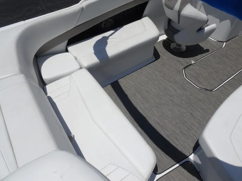 Slide: The Image of 2023 Four Winns H260 boat interior with white seating and gray flooring. - 11