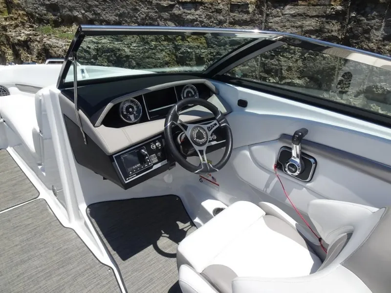 Slide: The Image of 2023 Four Winns H260 boat cockpit with modern steering and controls. - 14