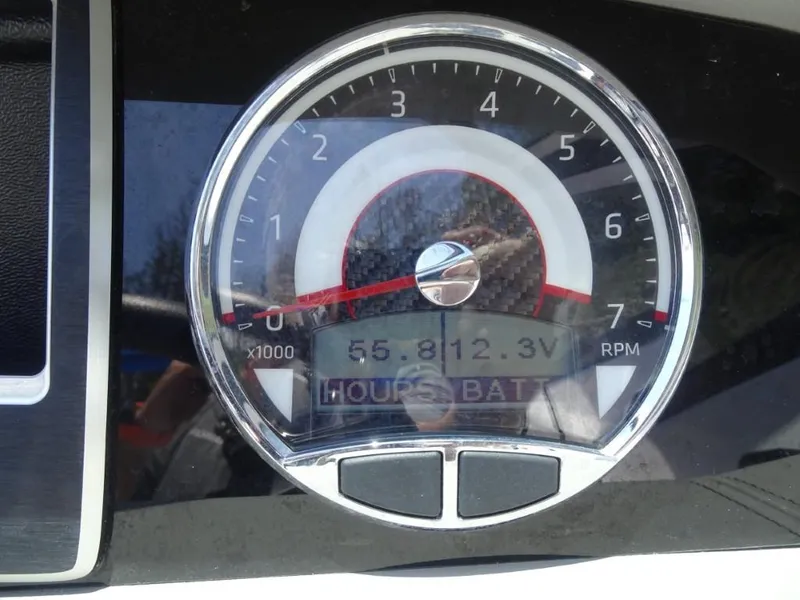 Slide: The Image of Close-up of 2023 Four Winns H260 tachometer displaying RPM and battery voltage. - 16