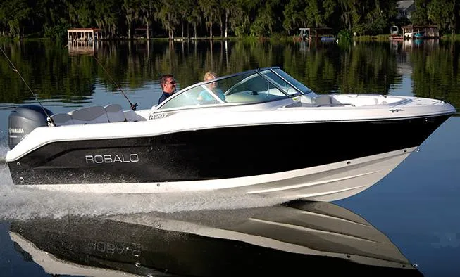 Slide: The Image of Manufacturer Provided Image: 2013 Robalo R207 Dual Console boat cruising on a calm lake. - 1