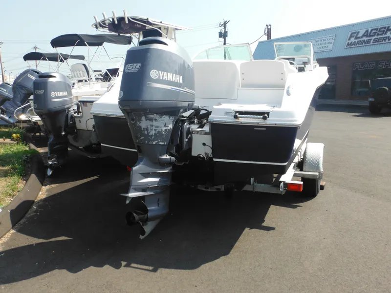 Slide: The Image of 2013 Robalo R207 Dual Console boat with Yamaha 150 engine, parked on a trailer. - 11