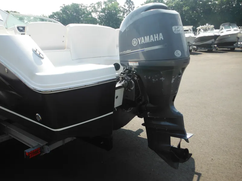 Slide: The Image of 2013 Robalo R207 Dual Console with Yamaha outboard motor in a parking lot. - 12