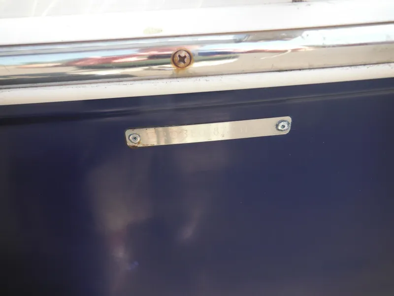 Slide: The Image of 2013 Robalo R207 Dual Console boat identification plate on blue hull. - 13