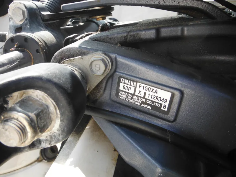 Slide: The Image of Close-up of Yamaha F150XA engine part on 2013 Robalo R207 Dual Console boat. - 15