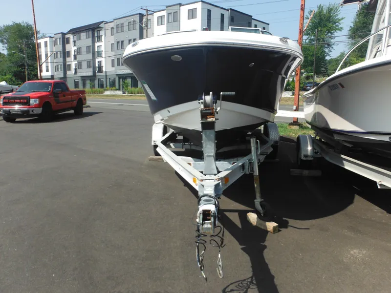 Slide: The Image of 2013 Robalo R207 Dual Console boat on trailer in parking lot. - 16