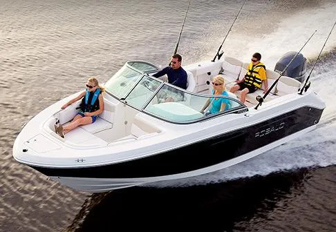 Slide: The Image of Manufacturer Provided Image: 2013 Robalo R207 Dual Console boat cruising with passengers on a lake. - 2
