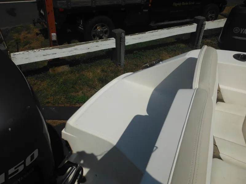 Slide: The Image of 2013 Robalo R207 Dual Console boat interior with Yamaha engine, parked outdoors. - 21