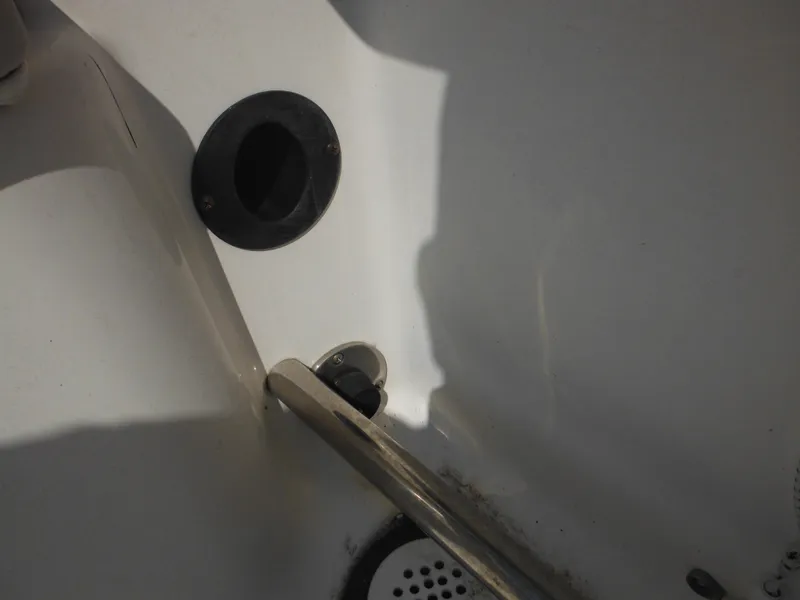 Slide: The Image of 2013 Robalo R207 Dual Console interior detail with drain and handle. - 23