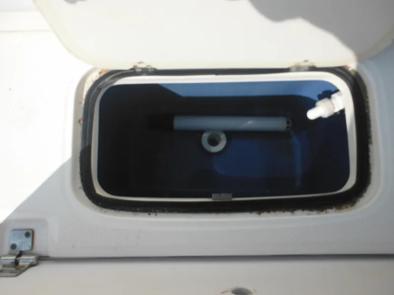 Slide: The Image of Open storage compartment on 2013 Robalo R207 Dual Console boat. - 26