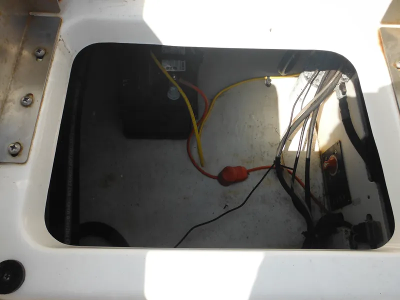 Slide: The Image of 2013 Robalo R207 Dual Console battery compartment with wiring and connections. - 27