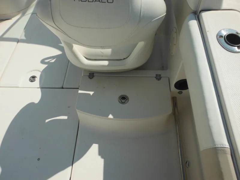 Slide: The Image of 2013 Robalo R207 Dual Console boat interior with seating and storage compartment. - 29