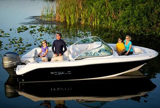 Slide: The Image of Manufacturer Provided Image: 2013 Robalo R207 Dual Console boat with passengers on a calm lake. - 3