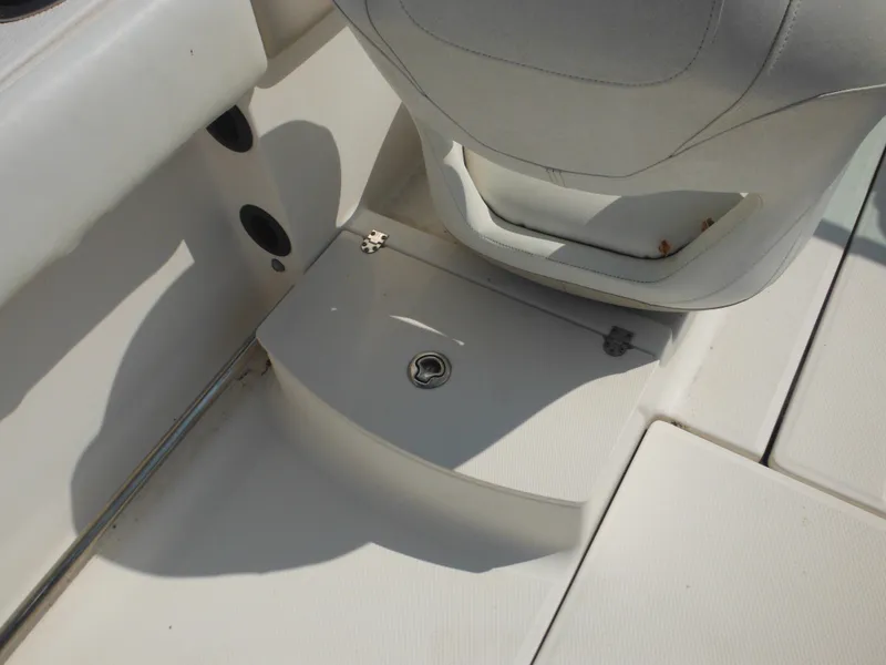 Slide: The Image of 2013 Robalo R207 Dual Console boat interior with storage compartment and seating. - 31