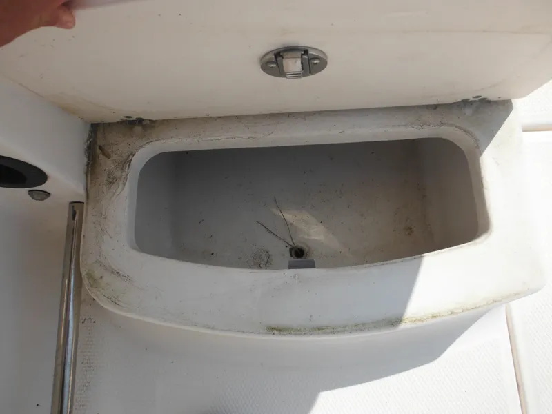 Slide: The Image of Open storage compartment on a 2013 Robalo R207 Dual Console boat. - 32