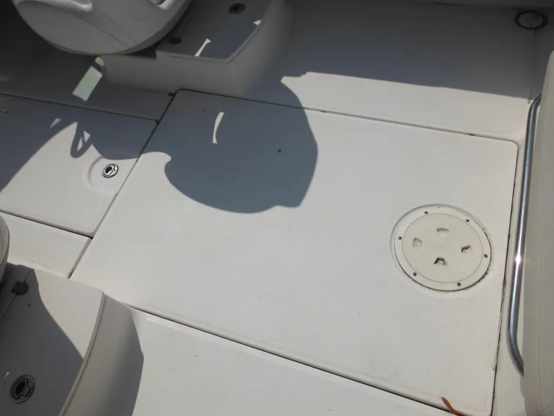 Slide: The Image of 2013 Robalo R207 Dual Console boat deck with storage hatch and seating area. - 33