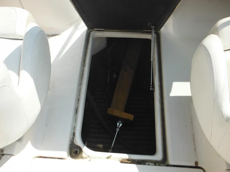 Slide: The Image of Open storage compartment on 2013 Robalo R207 Dual Console boat interior. - 35
