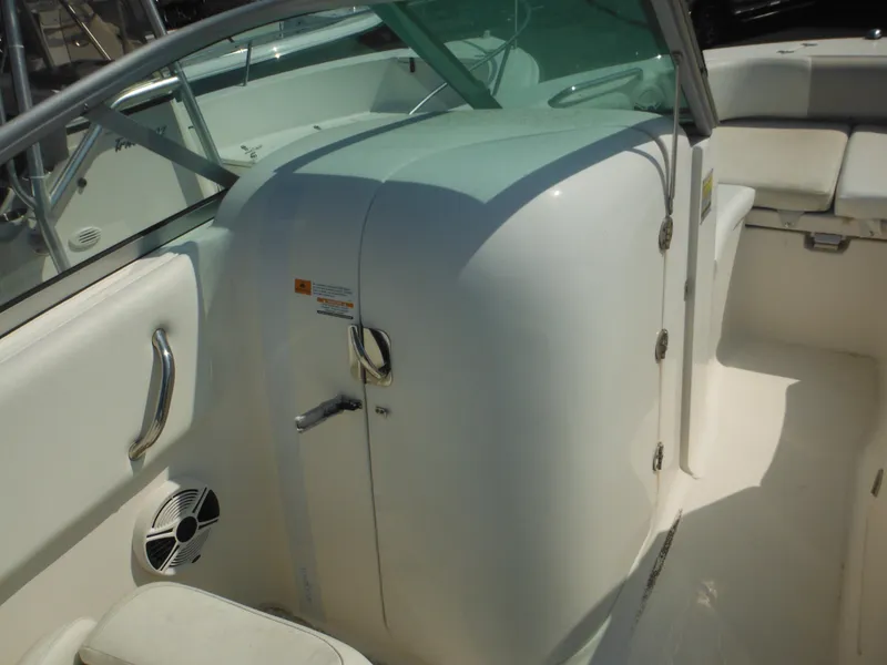 Slide: The Image of 2013 Robalo R207 Dual Console interior with seating and storage compartment. - 36