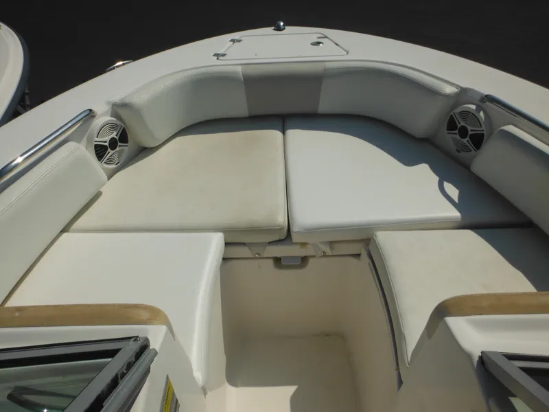 Slide: The Image of 2013 Robalo R207 Dual Console boat interior with cushioned seating and speakers. - 41