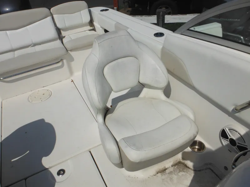 Slide: The Image of 2013 Robalo R207 Dual Console boat interior with white seating and cup holder. - 45