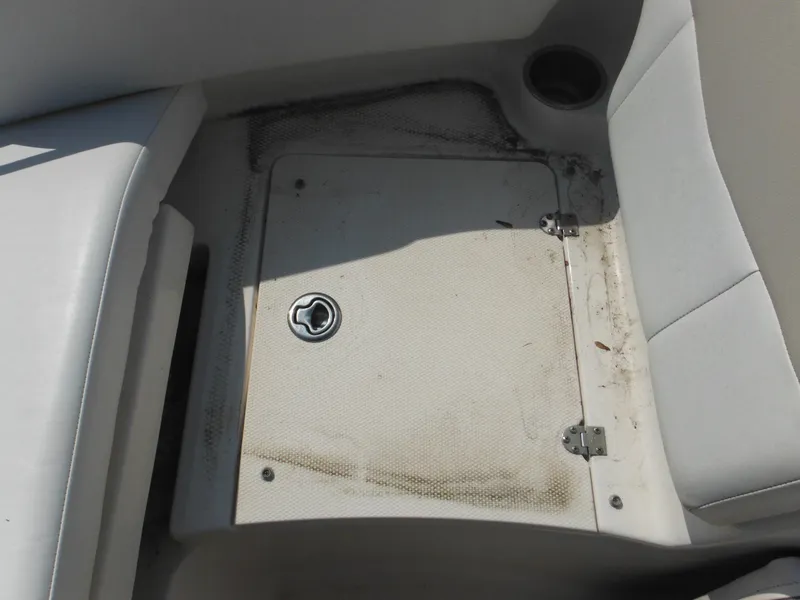 Slide: The Image of 2013 Robalo R207 Dual Console boat storage compartment with cup holder. - 48