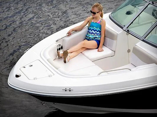 Slide: The Image of Manufacturer Provided Image: 2013 Robalo R207 Dual Console boat with a girl relaxing on the bow seat. - 5