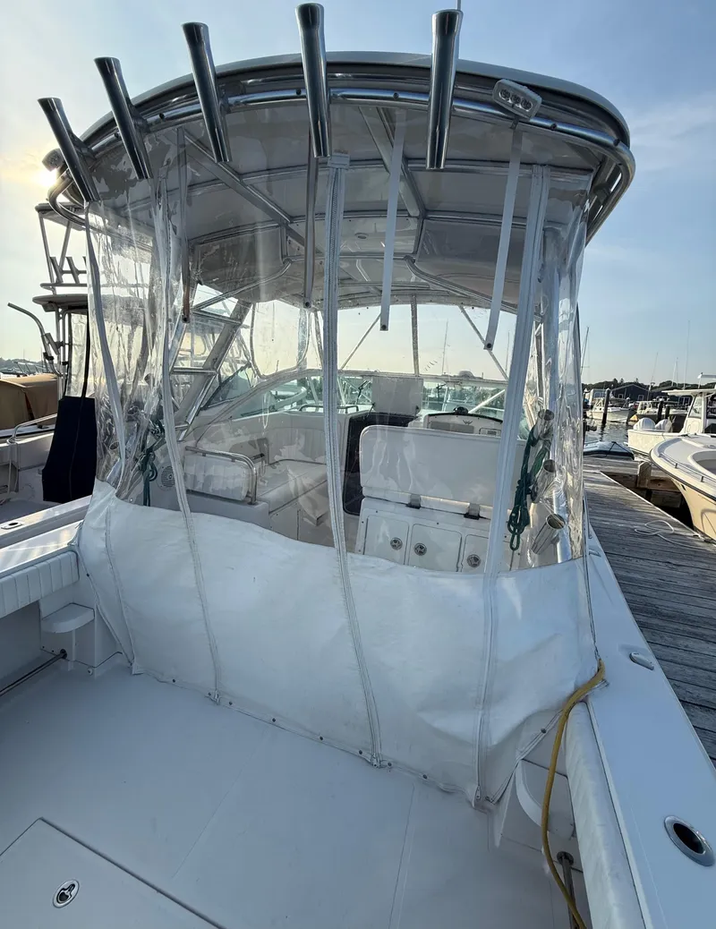 Slide: The Image of 2008 Southport 28 Express boat with clear canopy, docked at marina. - 10