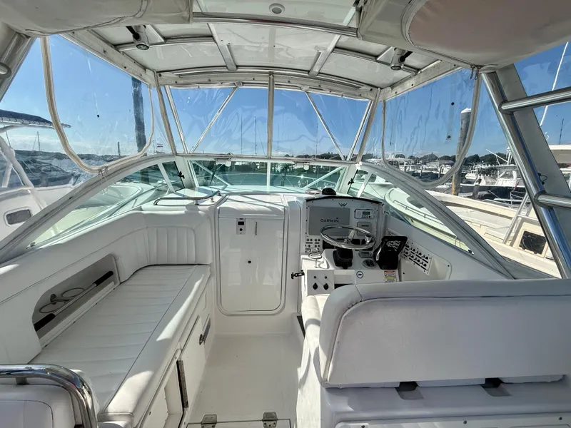 Slide: The Image of 2008 Southport 28 Express boat cockpit with steering wheel and seating, docked at marina. - 11