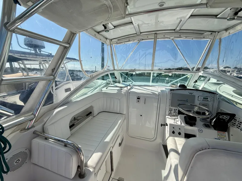 Slide: The Image of Interior of a 2008 Southport 28 Express boat with white seating and navigation equipment. - 12