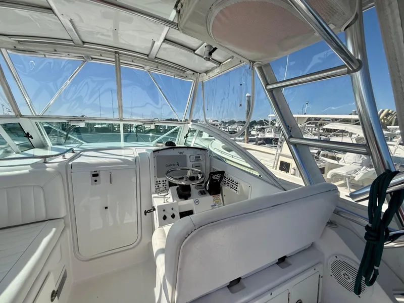 Slide: The Image of 2008 Southport 28 Express boat cockpit with steering wheel and navigation equipment. - 14