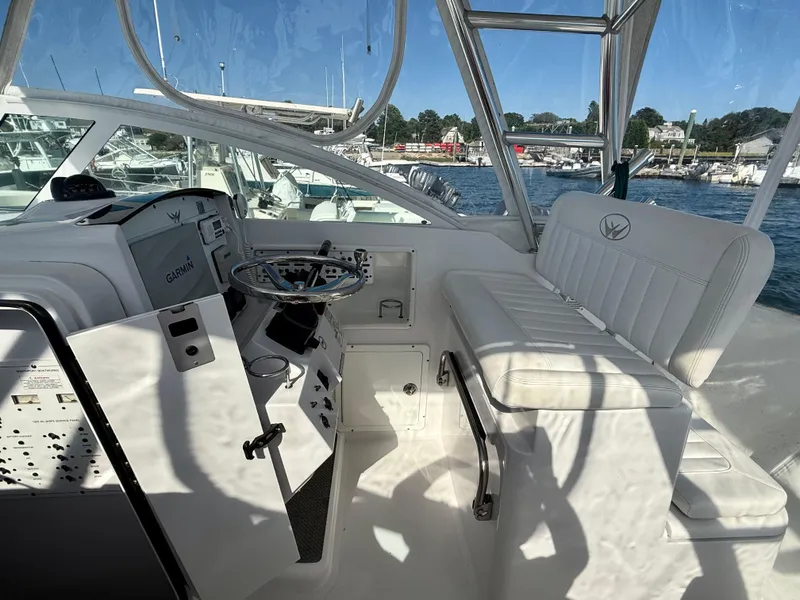 Slide: The Image of 2008 Southport 28 Express boat interior with steering wheel and seating. - 15