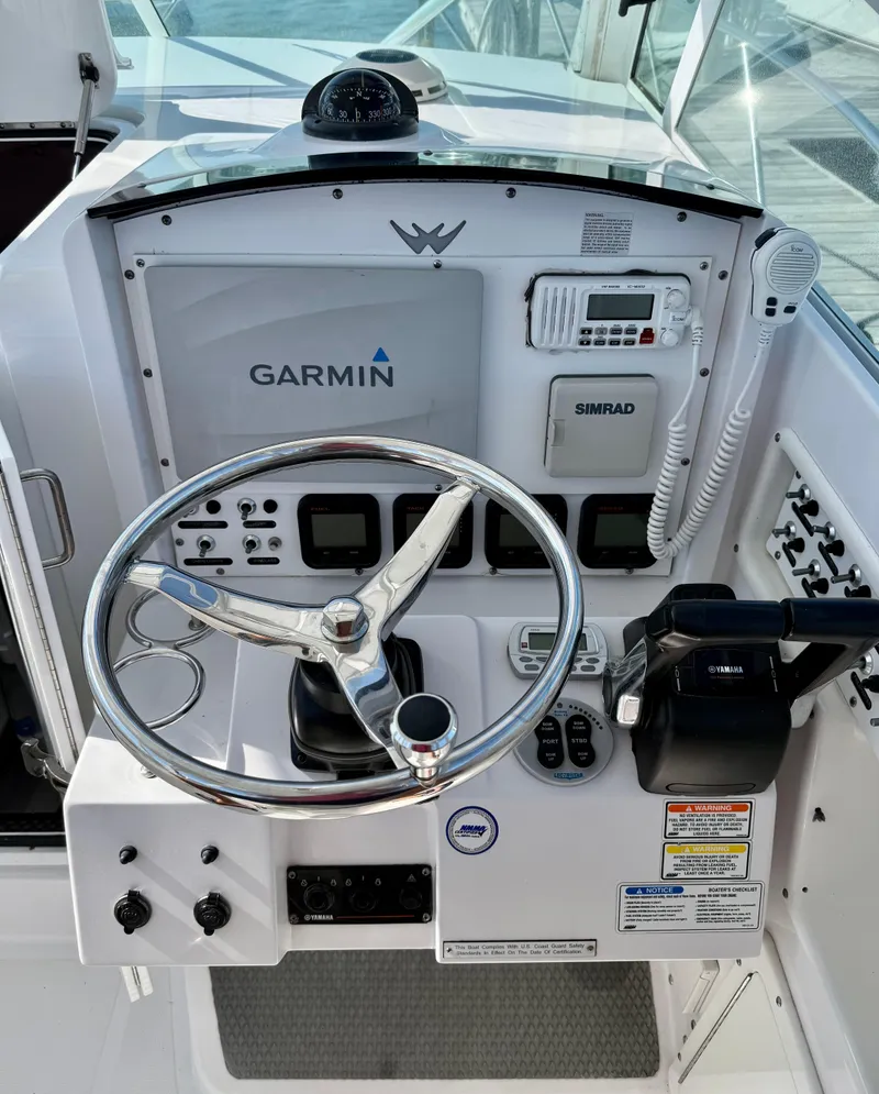 Slide: The Image of Control panel of a 2008 Southport 28 Express boat with Garmin and Simrad equipment. - 17