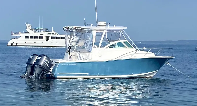 Slide: The Image of 2008 Southport 28 Express boat with dual outboard motors on calm water. - 2