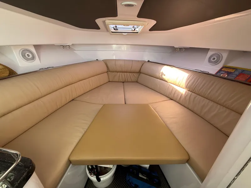 Slide: The Image of 2008 Southport 28 Express cabin interior with beige seating and overhead hatch. - 21